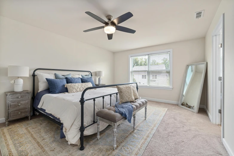 an empty bedroom with a bed and dresser