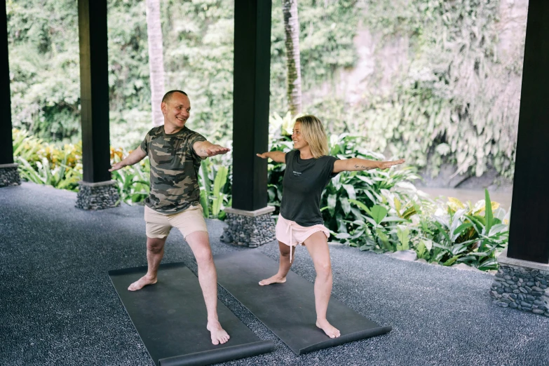 a man and woman doing yoga poses together