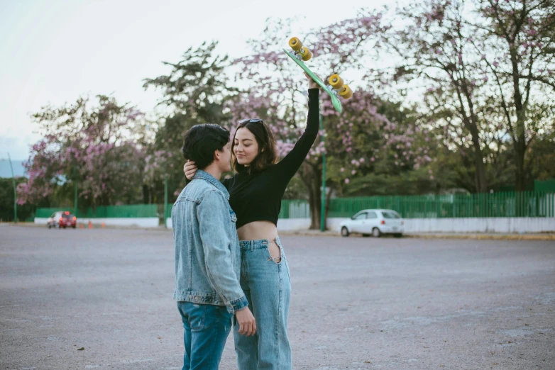 a woman holding a snowboard next to a man