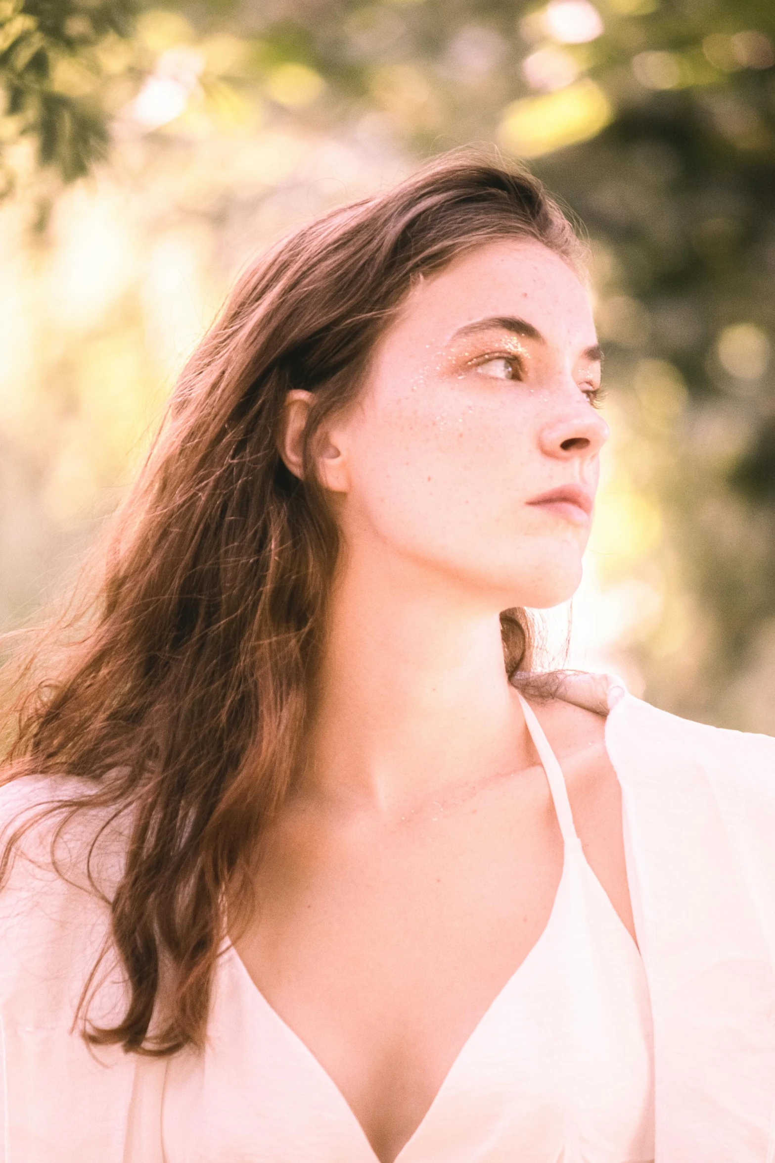 a young woman standing outside in a park