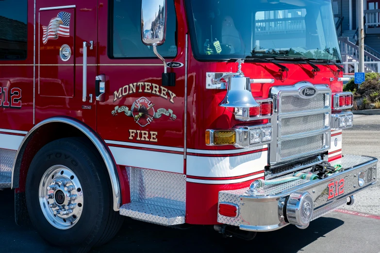 a fire truck with red and white stripes parked in a lot