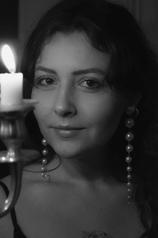 a woman in a  holding a lit candle with it's head