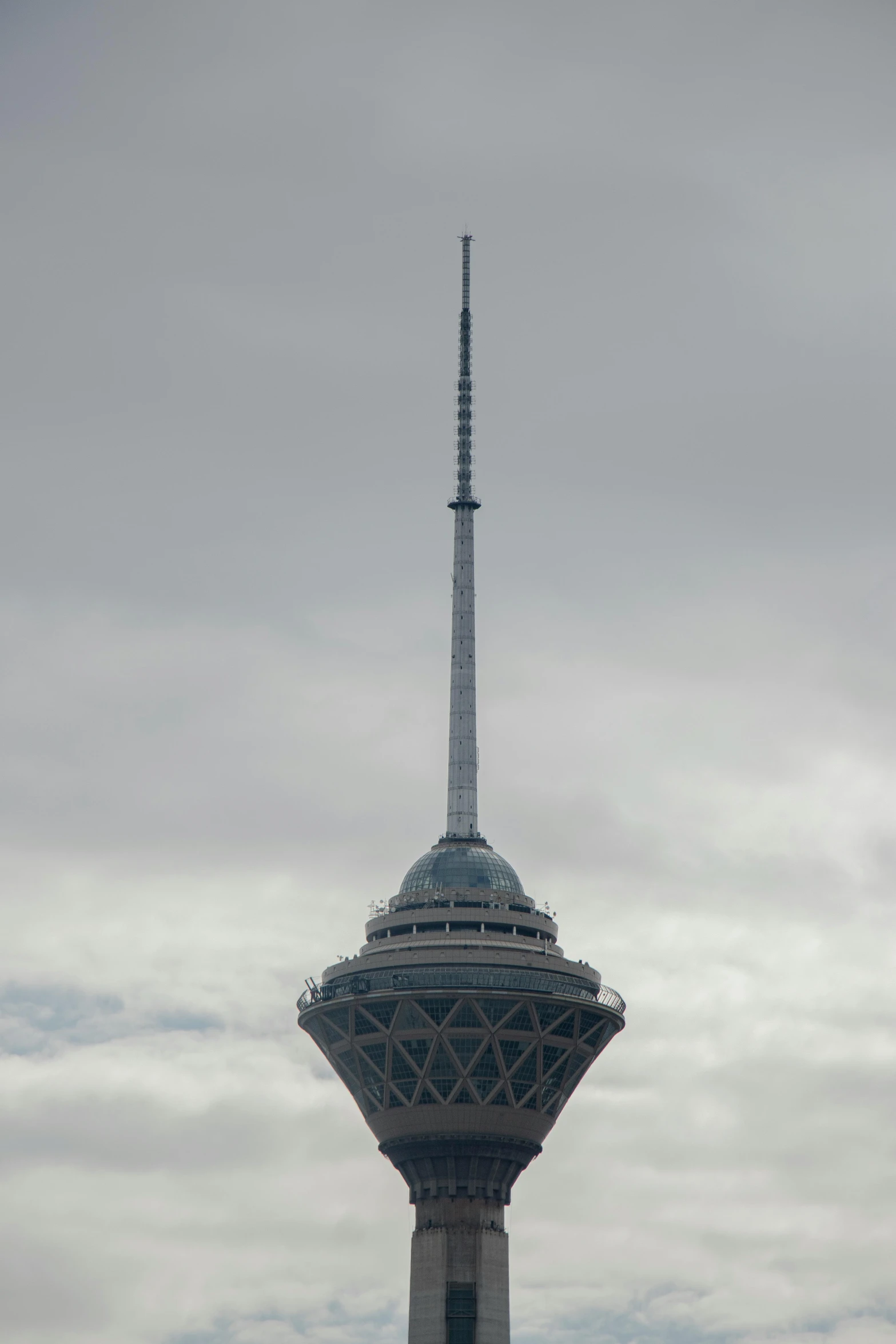 the tall tower is built on top of a hill