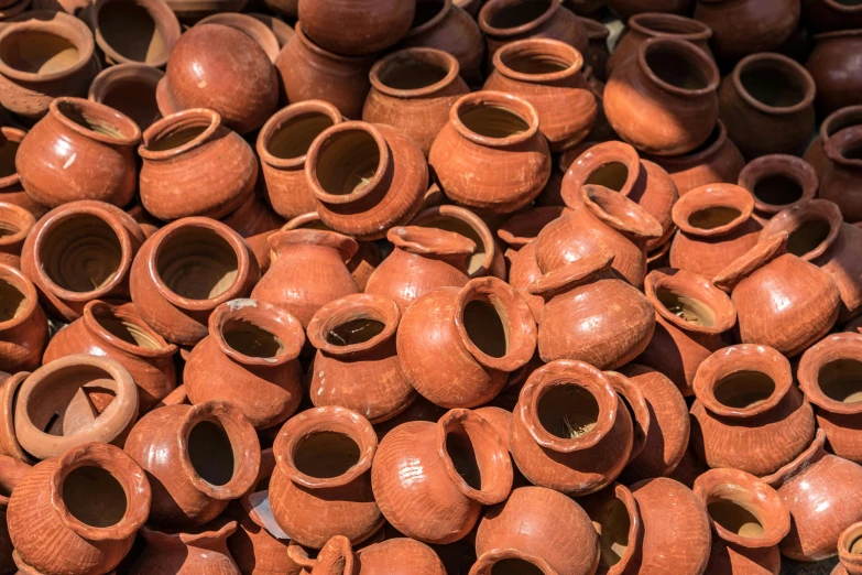 lots of clay pots that are stacked together