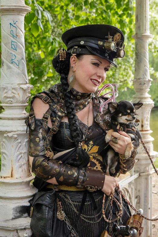 a woman dressed in elaborate costumes holds a dog
