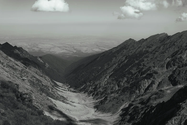 mountains are shown with a stream in the foreground