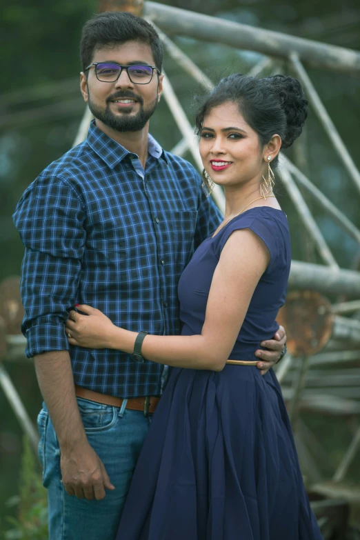 a young couple is smiling while standing side by side