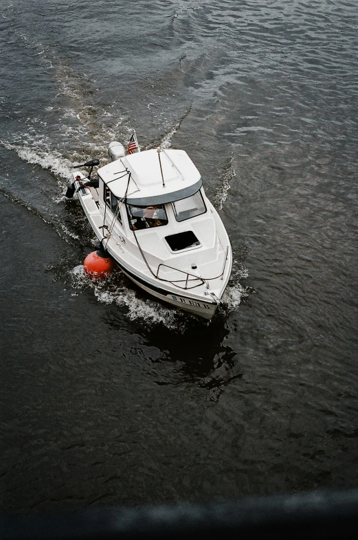 a small white boat in a body of water