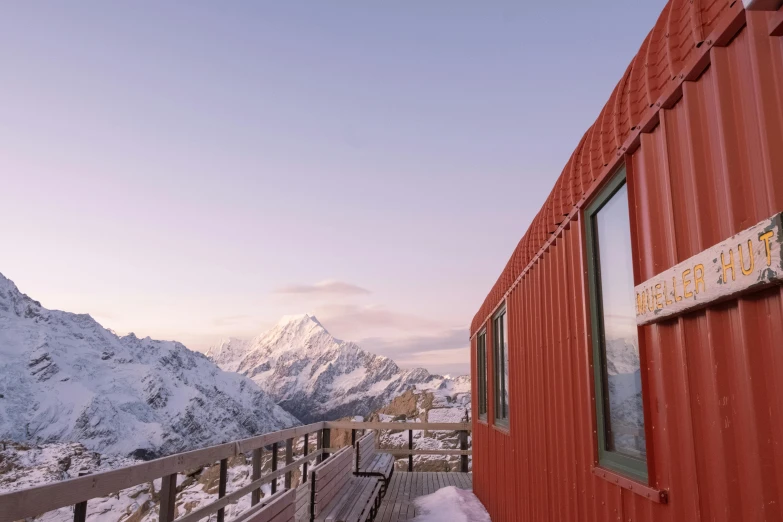 the red house overlooks mountains with no one in it