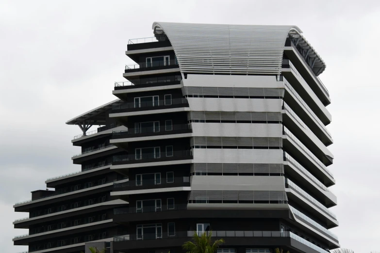 a tall skyscr with several levels of windows and balconies on the top level