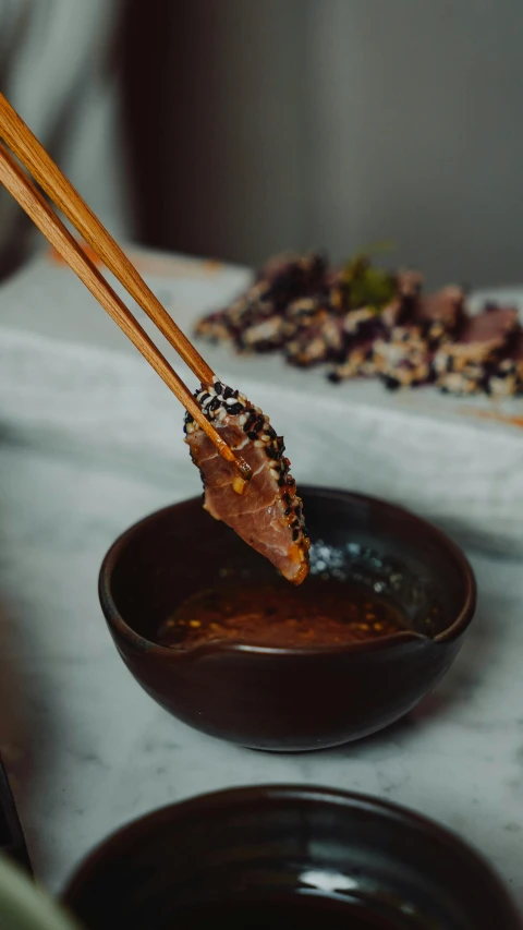 chopsticks with chopsticks sticking out of bowl of stir fry food