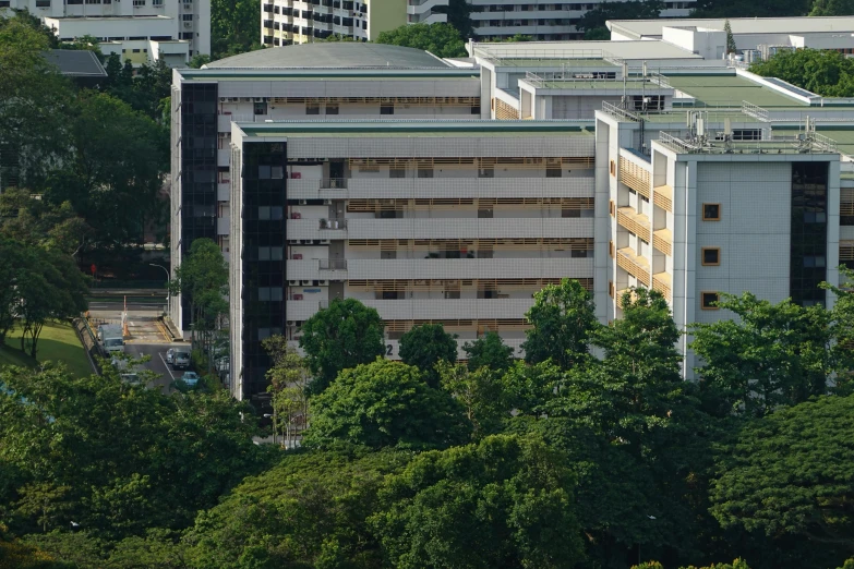 many large buildings in a city surrounded by trees