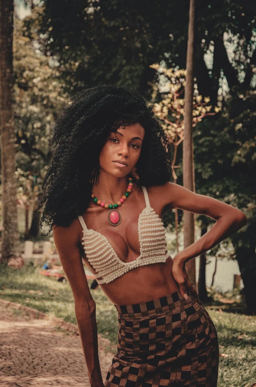 the woman with her hair in a bikini top poses for a portrait