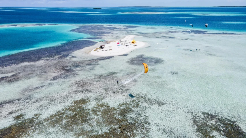 people are flying kites over the water on the island