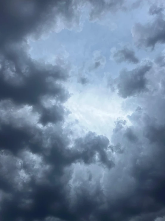 the plane is flying against a dark, cloudy sky