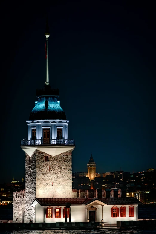 a very big building with a clock tower at night