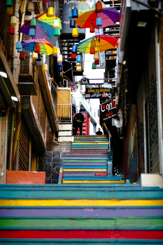 colorful steps with umbrellas hanging from the ceiling