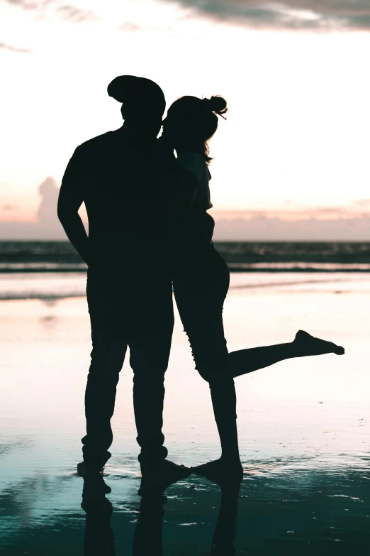 the silhouette of two people standing next to each other