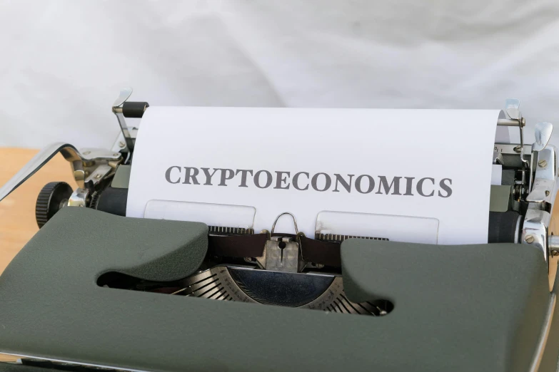 a typewriter with a paper that says crypttoeconics on it