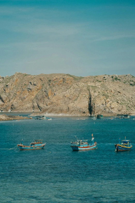 a number of boats on a body of water