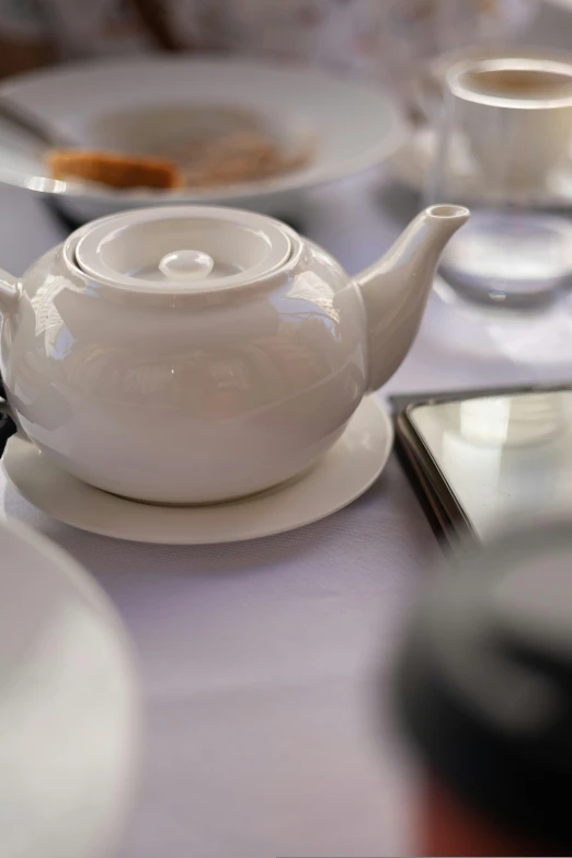 a cup and saucer on top of a white table