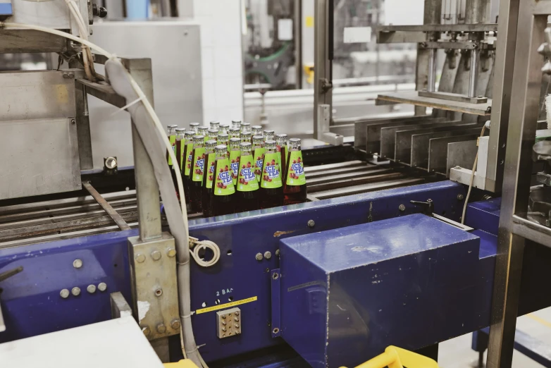 a machine has several bottles of soda on it