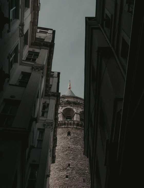 tall buildings are shown against the sky on a cloudy day