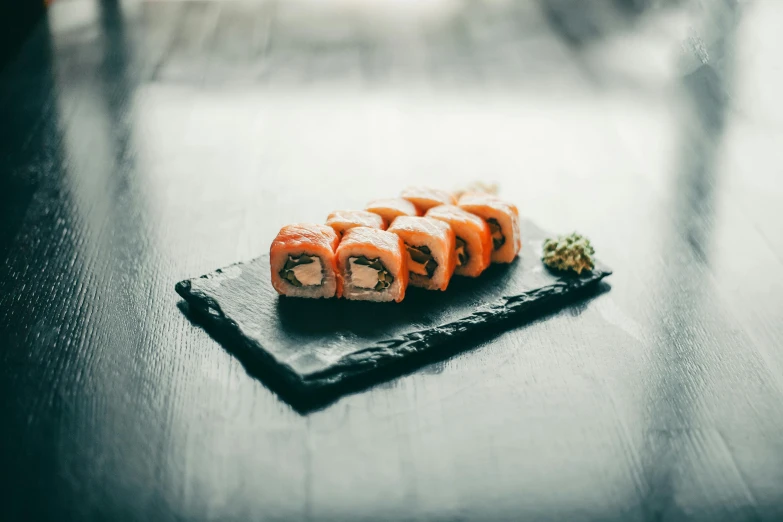 some kind of sushi on a black surface