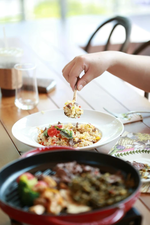 a person reaching for food at a table