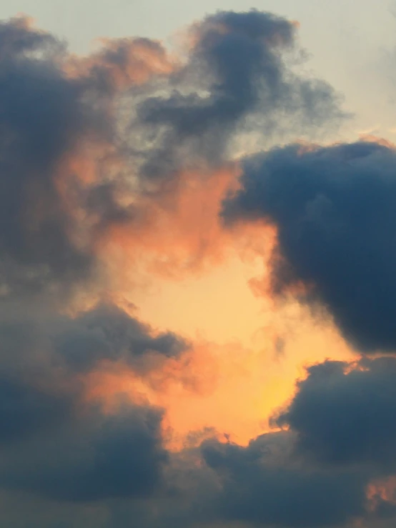 airplane flying in cloudy sky with orange light