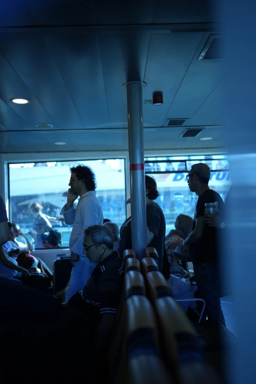 group of people sitting next to each other with luggage