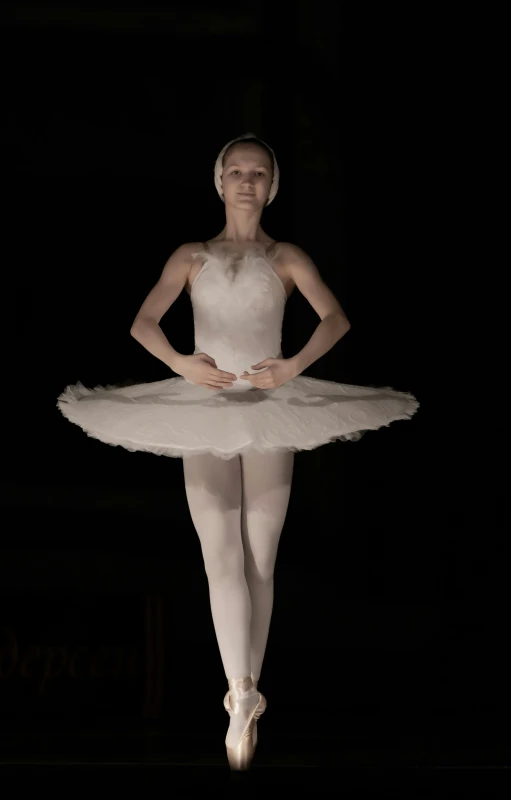 a ballerina dressed in white posing for a picture
