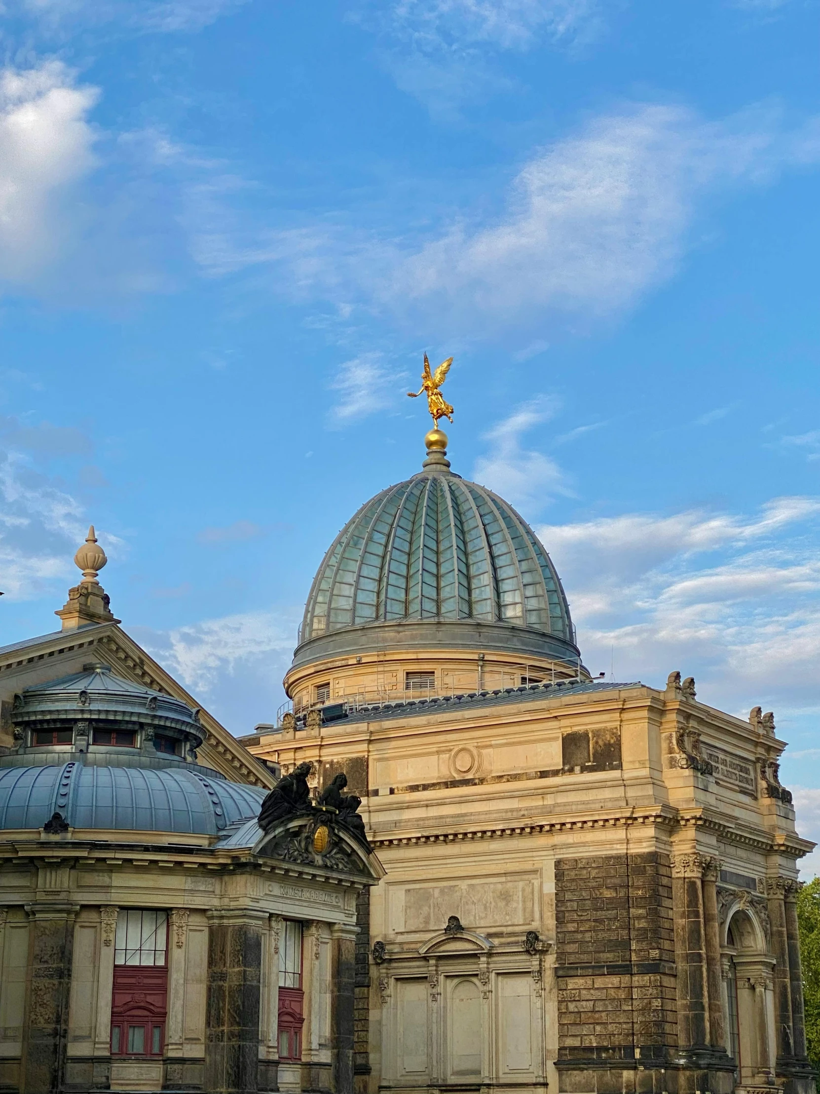 the top part of a large building with a sky background