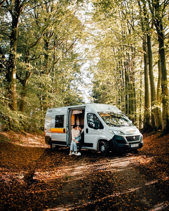 a van parked in the middle of a forest