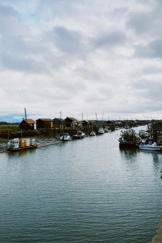 the harbor in the town has several small boats moored at it