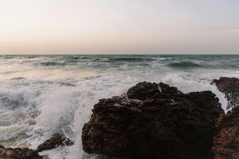 waves hitting onto the rocks with a small amount of surf