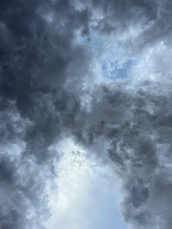 an airplane is flying in an overcast sky