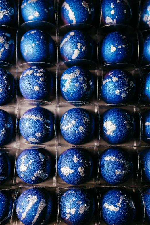 blue and white speckled eggs in a display box