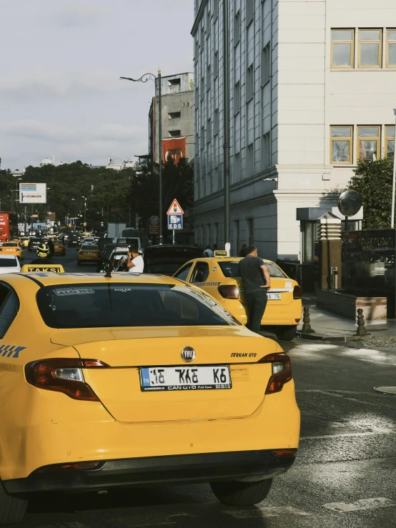 a street with taxis that are sitting in front of the road