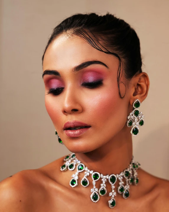 woman wearing necklace and earrings with jeweled accents