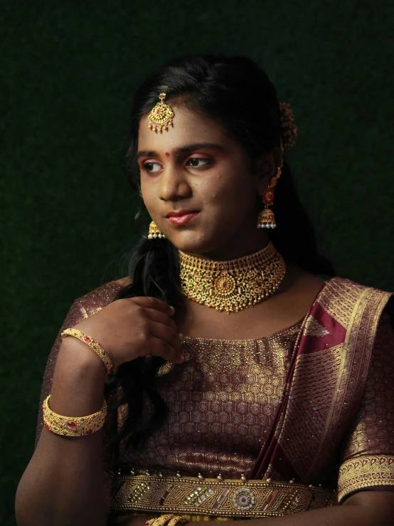 an indian woman in a bridal outfit with necklace and earring