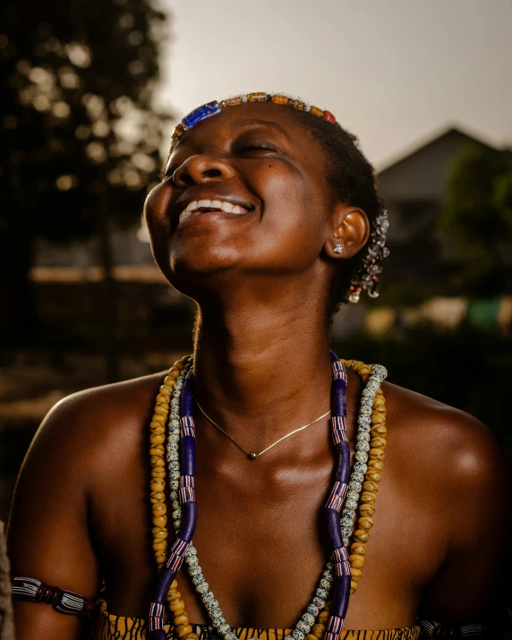 a black woman in an ethnic dress and some beads