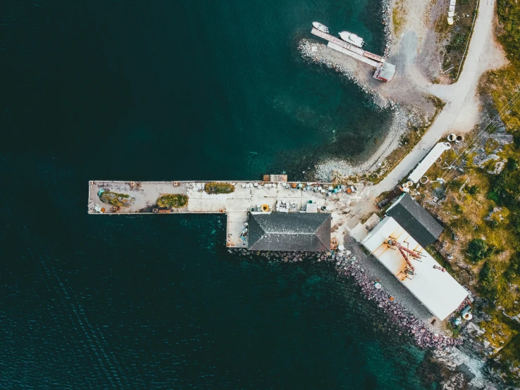 an aerial view of a pier and a boat