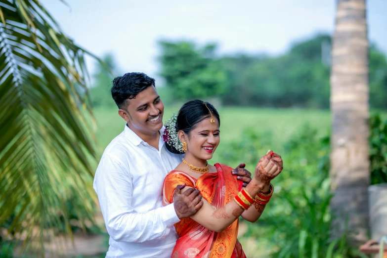 the couple is dancing outside in their colorful outfits