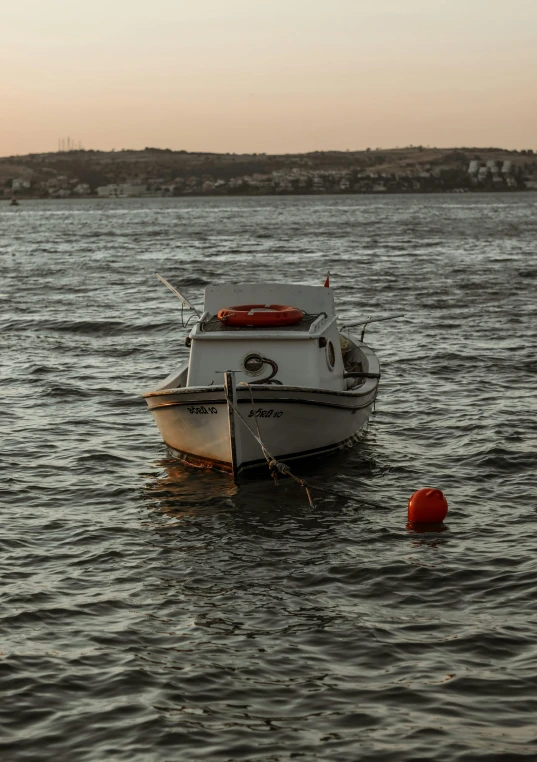 a white boat floating on a large body of water