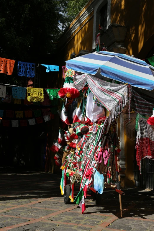 there are many colorful ribbons and umbrellas on display