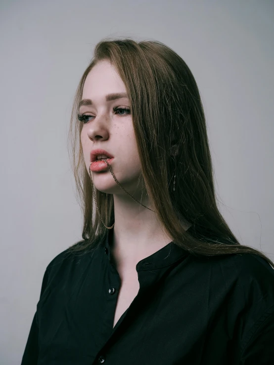 woman with long blonde hair wearing a black shirt and posing