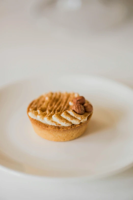 a small cookie with some nuts on top of it