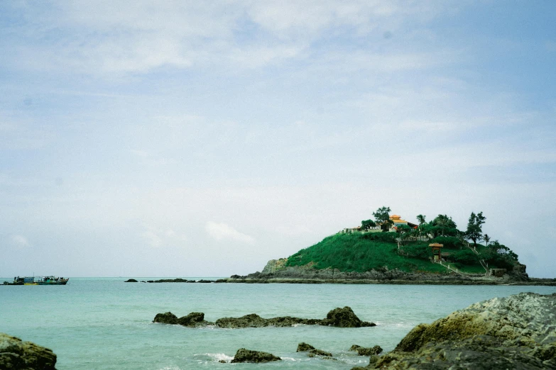 the island is surrounded by rocks with people in it