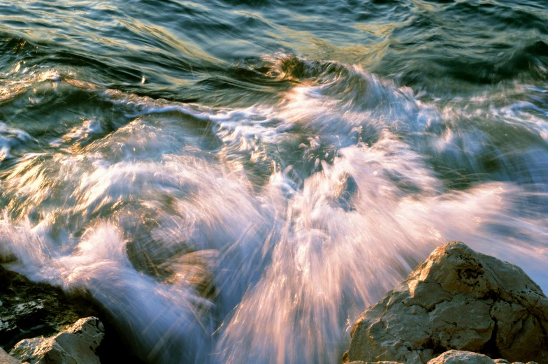 waves crashing on rocks near the shore